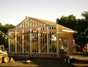 Three views of the Solar Shed framing in progress.